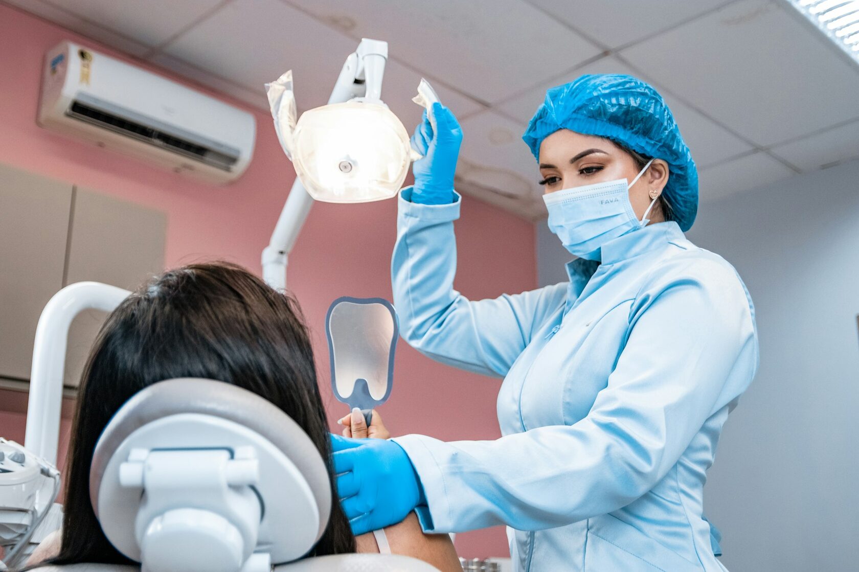 Dentist carefully examining a patient's teeth during a routine check-up